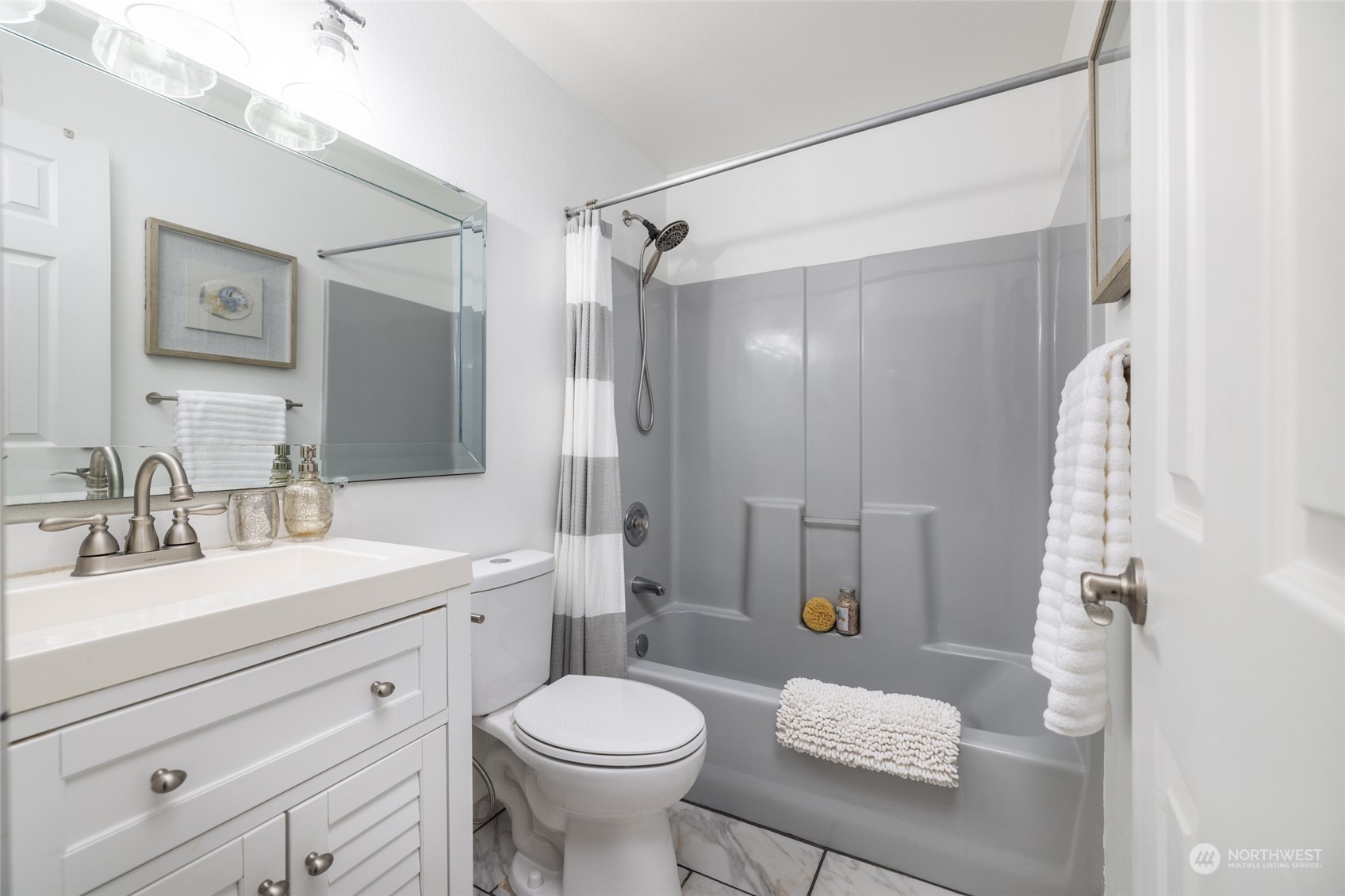 2131 North 88th Street Seattle, WA 98103 - Photo 20 of 28 a bathroom with a sink toilet a mirror and shower