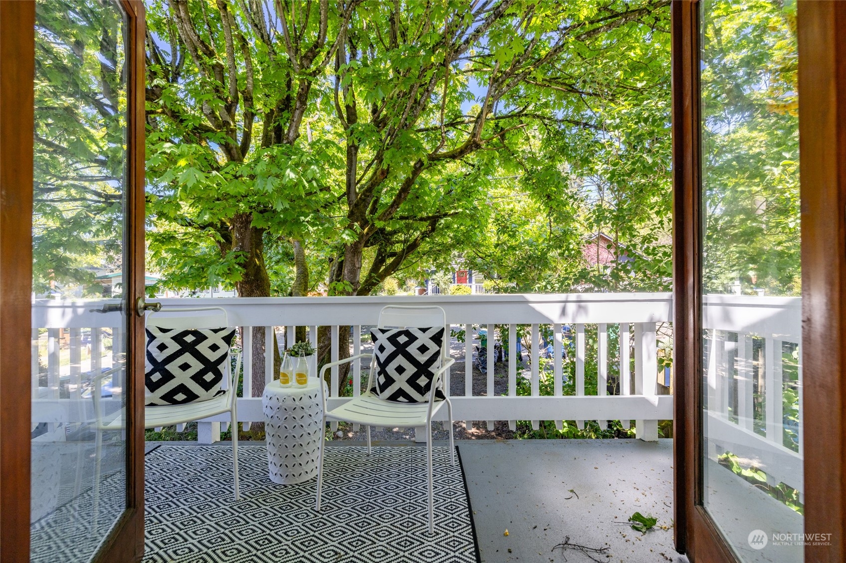 2131 North 88th Street Seattle, WA 98103 - Photo 9 of 28 a deck are with a bench and white chairs