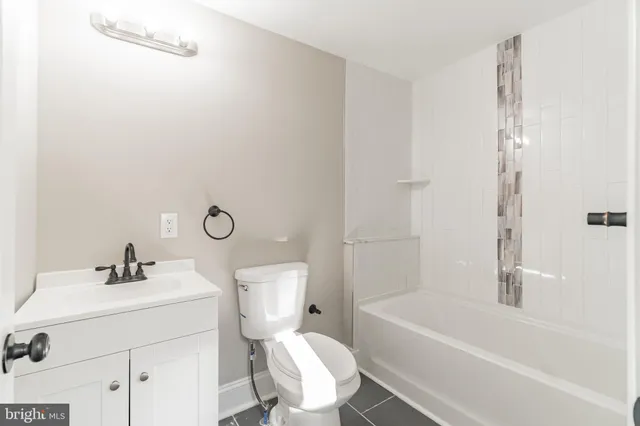 a bathroom with a sink toilet and bathtub