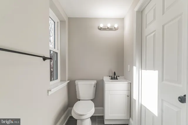 a white toilet sitting next to a bathroom sink