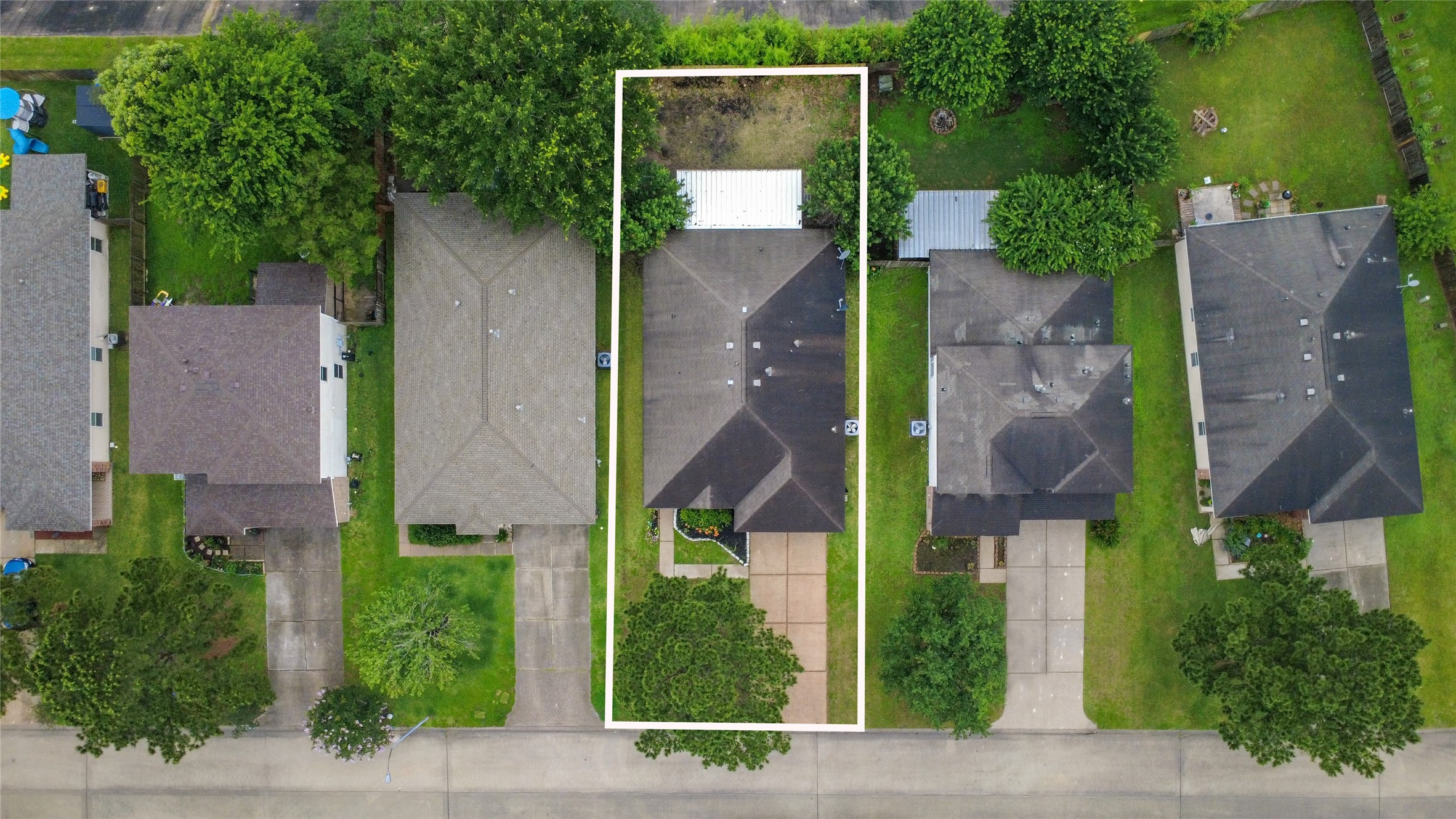24019 Kingbriar Drive Spring, TX 77373 - Photo 4 of 41 A precise top-down aerial perspective clearly outlining the property boundaries, providing a detailed look at the dark shingle roof, integrated carport, and geometric layout of the home and yards.