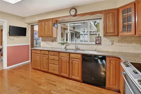 a kitchen with stainless steel appliances granite countertop a sink stove and microwave