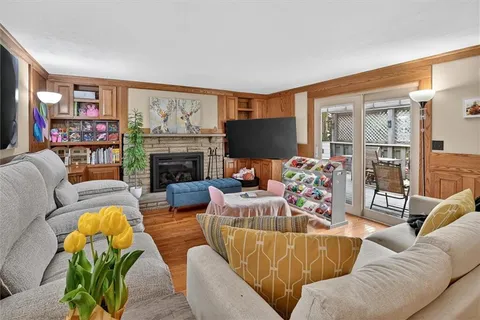 a living room with furniture fireplace and a flat screen tv