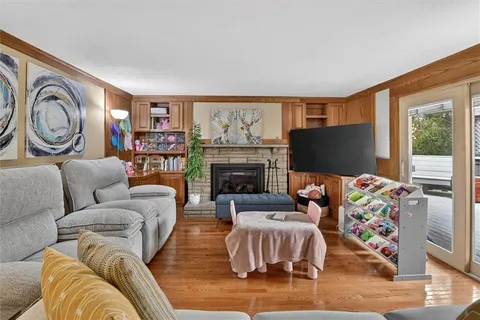 a living room with fireplace furniture and a flat screen tv