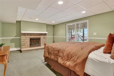 a bedroom with a bed and a fireplace