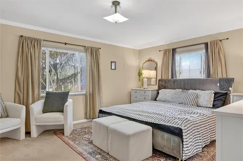 a bedroom with a large bed and a couch
