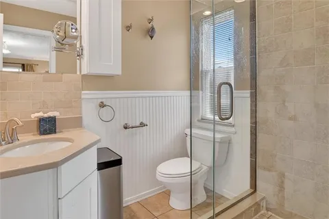 a bathroom with a sink toilet and shower