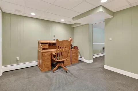 a view of a room with table and chairs