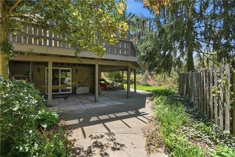 a view of a patio with table and chairs and potted plants