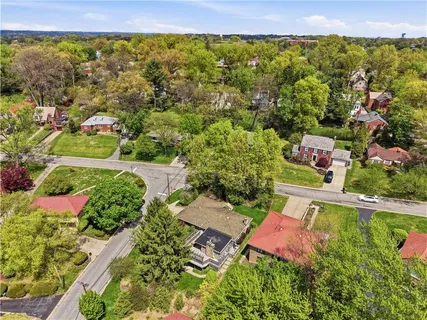 an aerial view of a house with a yard