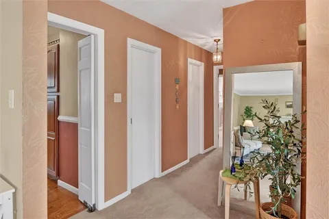a very nice looking room with a large mirror and dining room
