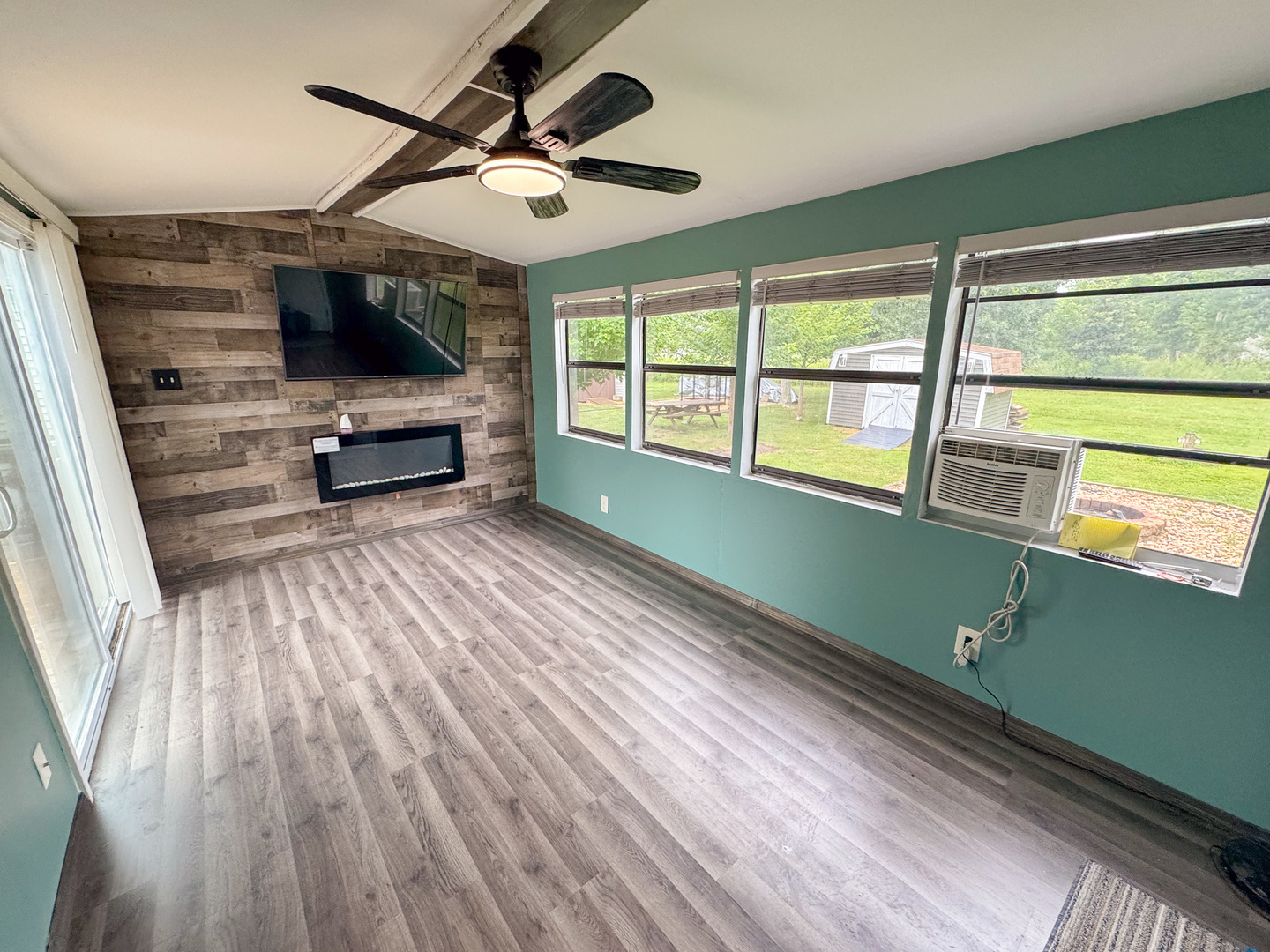 22-103 Woodhaven Sublette, IL 61367 - Photo 17 of 18 a view of room with window wooden floor and flat screen tv