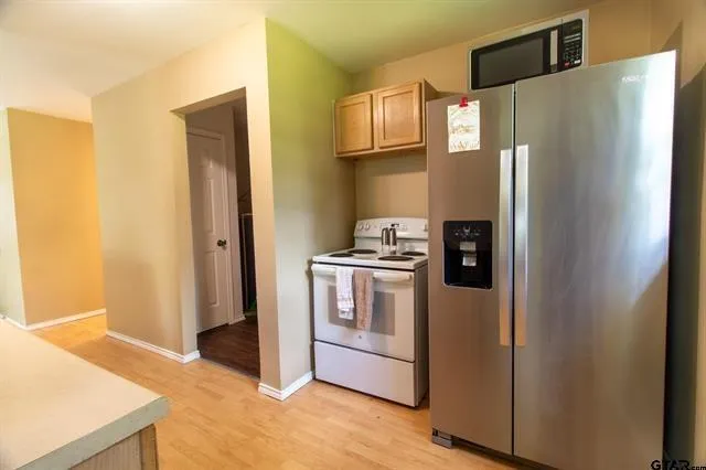 a kitchen with stainless steel appliances a refrigerator and a stove