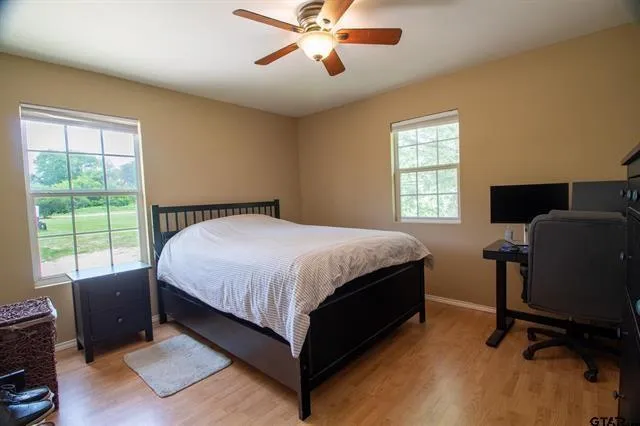 a bedroom with a bed window and a desk