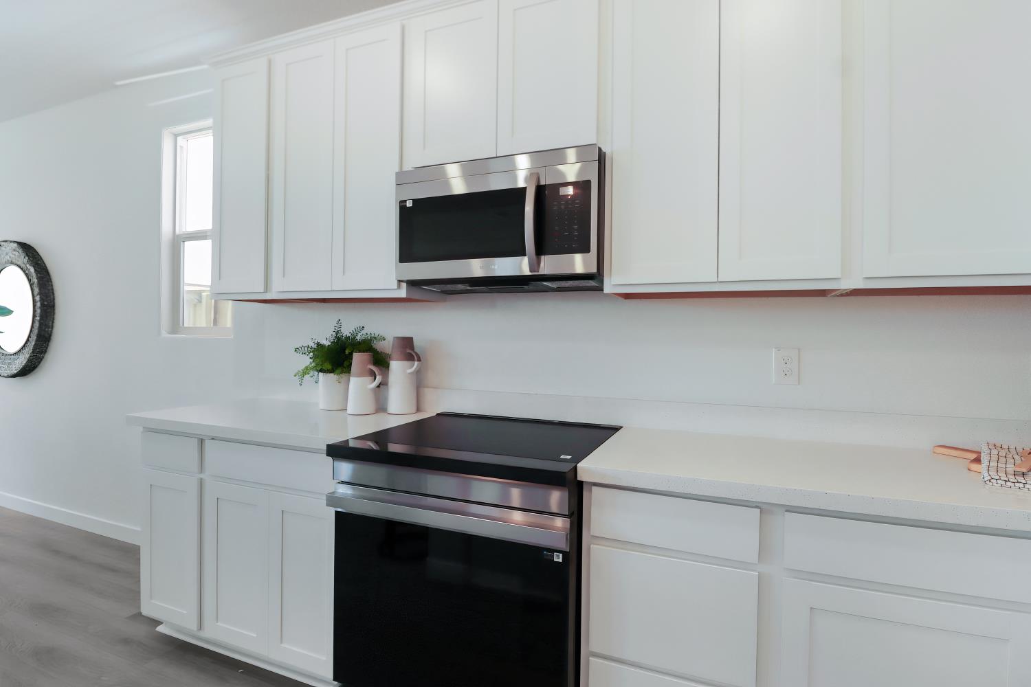 1108 Ashera Street Rocklin, CA 95765 - Photo 12 of 27 a kitchen with stainless steel appliances granite countertop white cabinets a microwave a sink and a white wooden cabinets