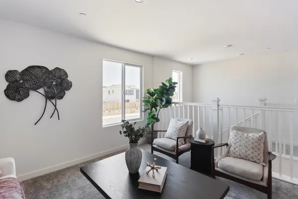 a living room with furniture flowerpot and wooden floor