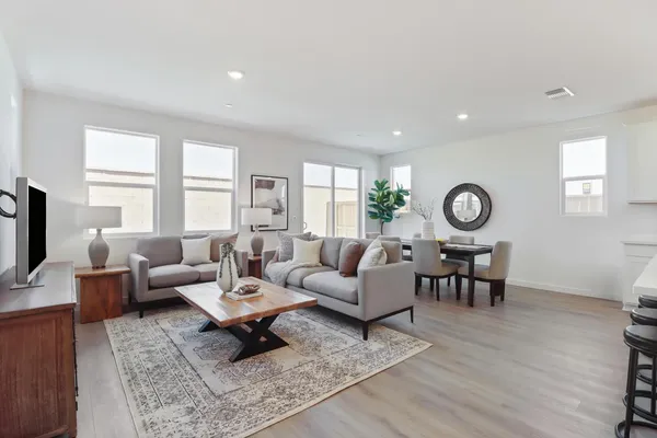 a living room with furniture wooden floor and window