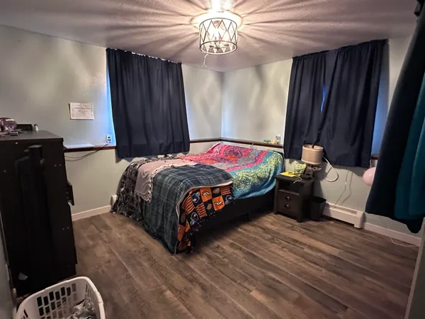 a bedroom with a bed and a mirror