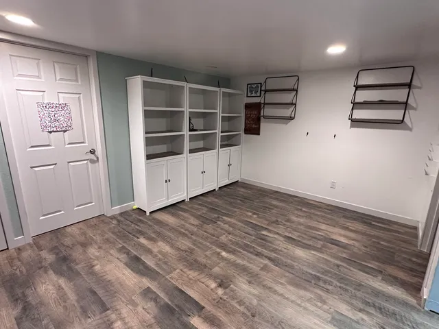 a bedroom with a bed a mirror and a flat screen tv