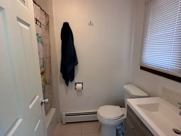 a view of empty room with wooden floor and closet