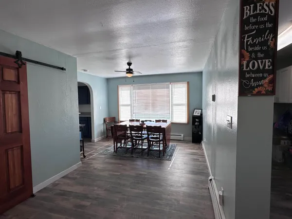 a view of a dining room with furniture window and wooden floor
