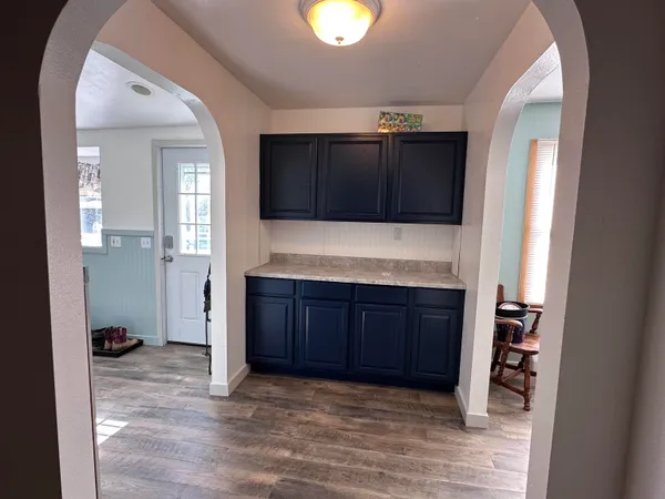 a view of an empty room with cabinet and cabinet