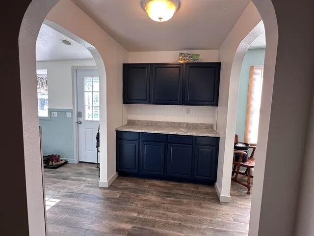 a view of an empty room with cabinet and cabinet