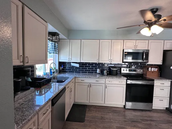 a kitchen with a sink cabinets and window
