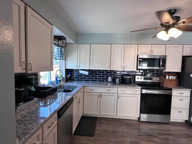 a kitchen with a sink cabinets and window