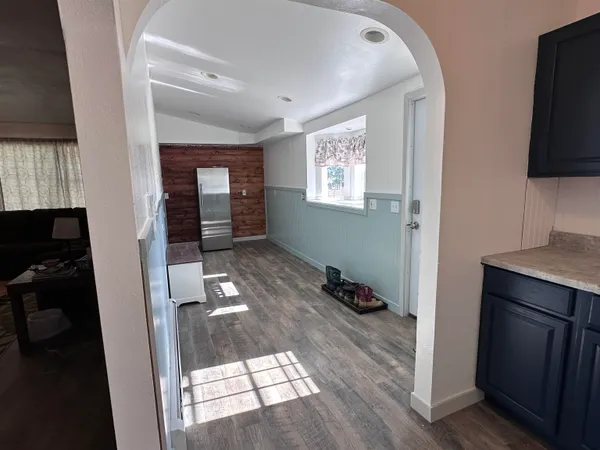 a hallway with a view of living room and window