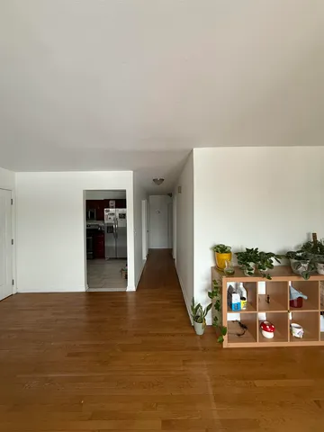 a view of a living room with furniture and a floor to ceiling window