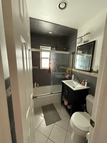 a bathroom with a sink a toilet and bathtub