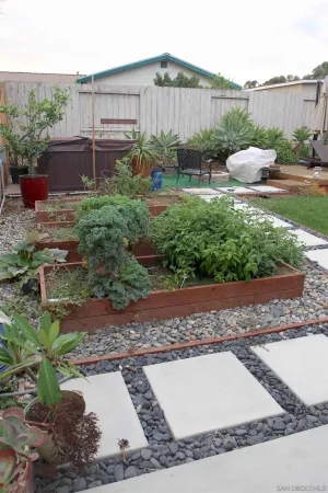 a view of a backyard with plants and outdoor seating