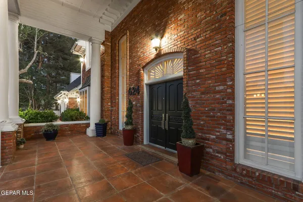 a building outdoor space with patio furniture and garden