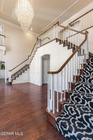 a view of an empty room with wooden floor fireplace and a window