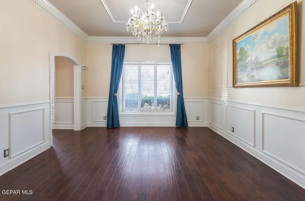 en empty room with wooden floor and windows