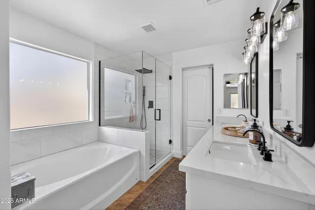 a bathroom with a tub sink and mirror
