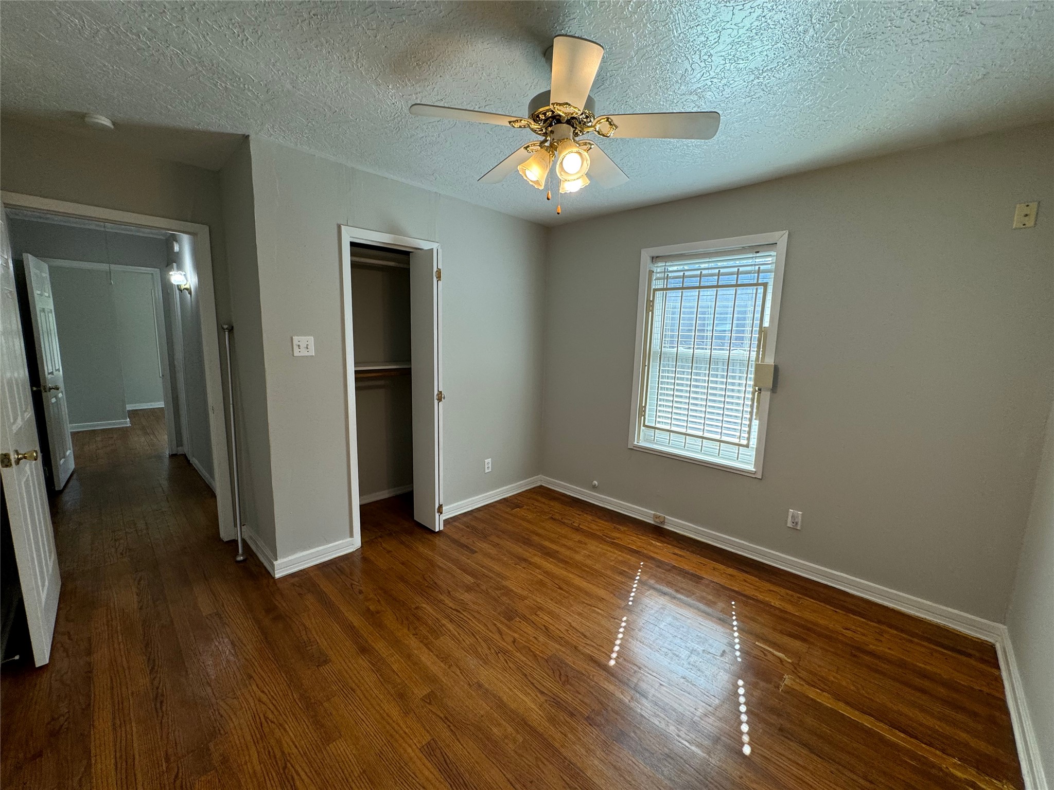 125 Pomeroy Street Pasadena, TX 77506 - Photo 16 of 19 wooden floor in an empty room with a window