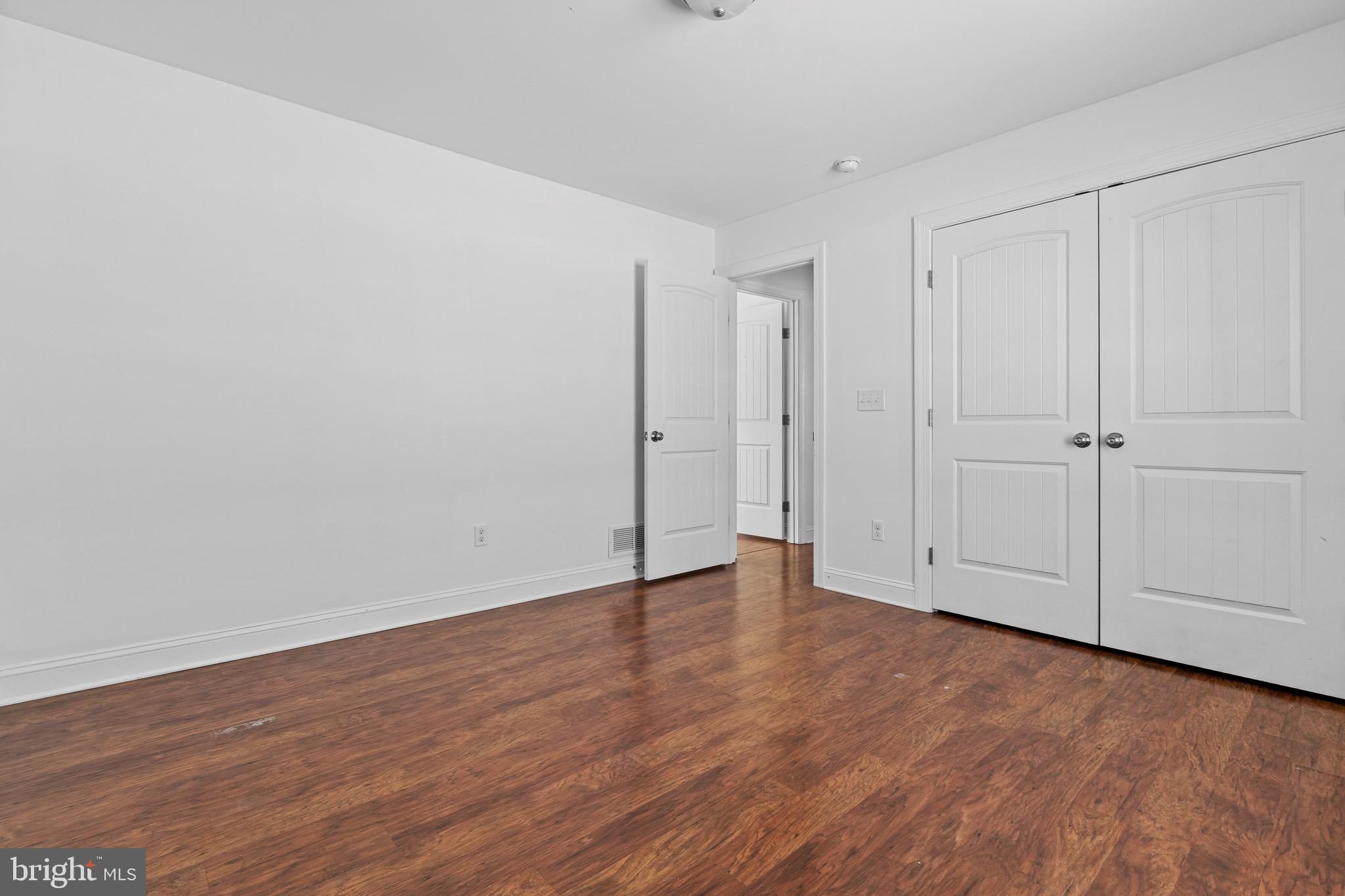 7180 Shawnee Road Milford, DE 19963 - Photo 13 of 20 a view of an empty room and wooden floor