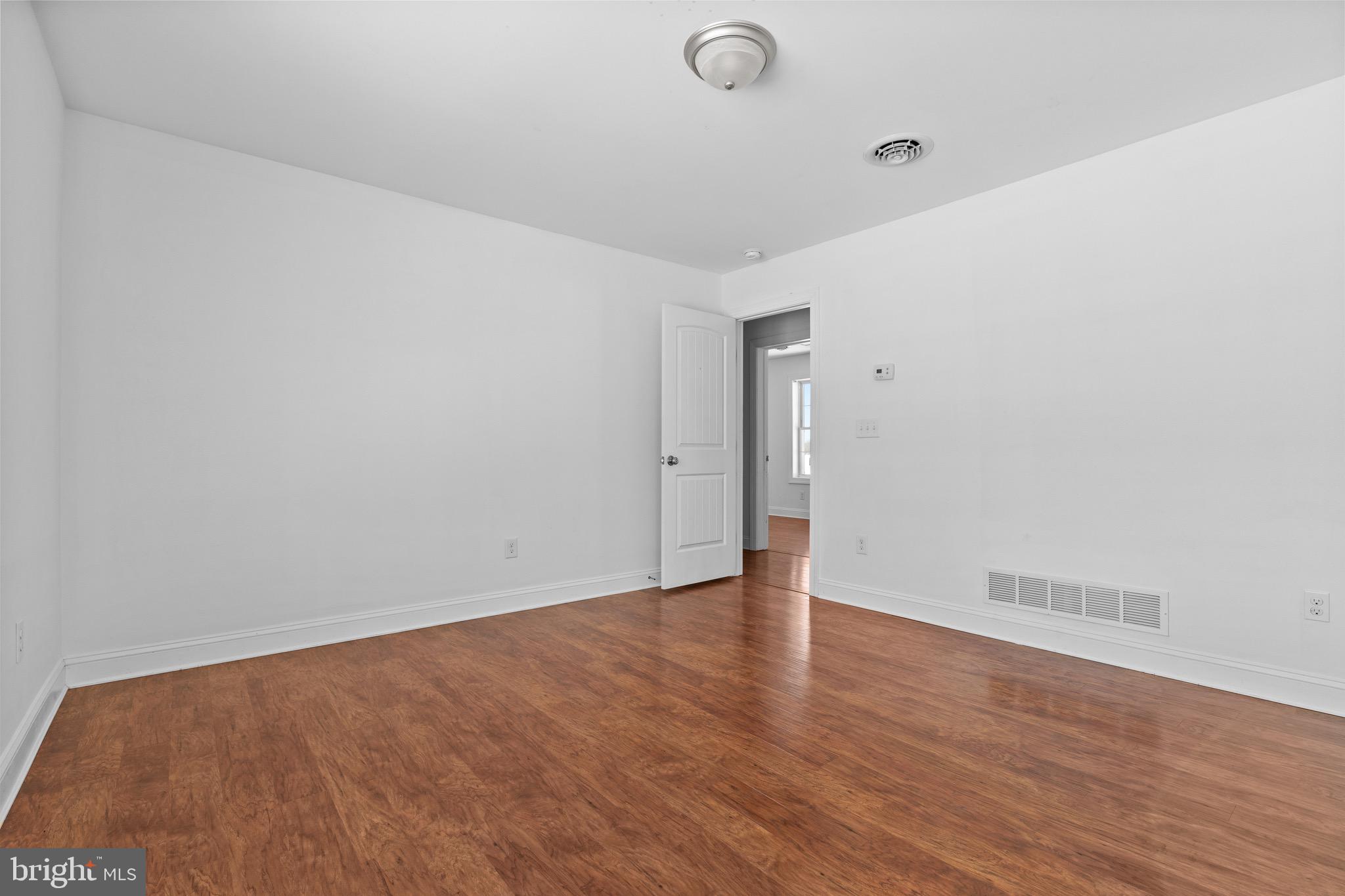 7180 Shawnee Road Milford, DE 19963 - Photo 15 of 20 a view of an empty room with wooden floor