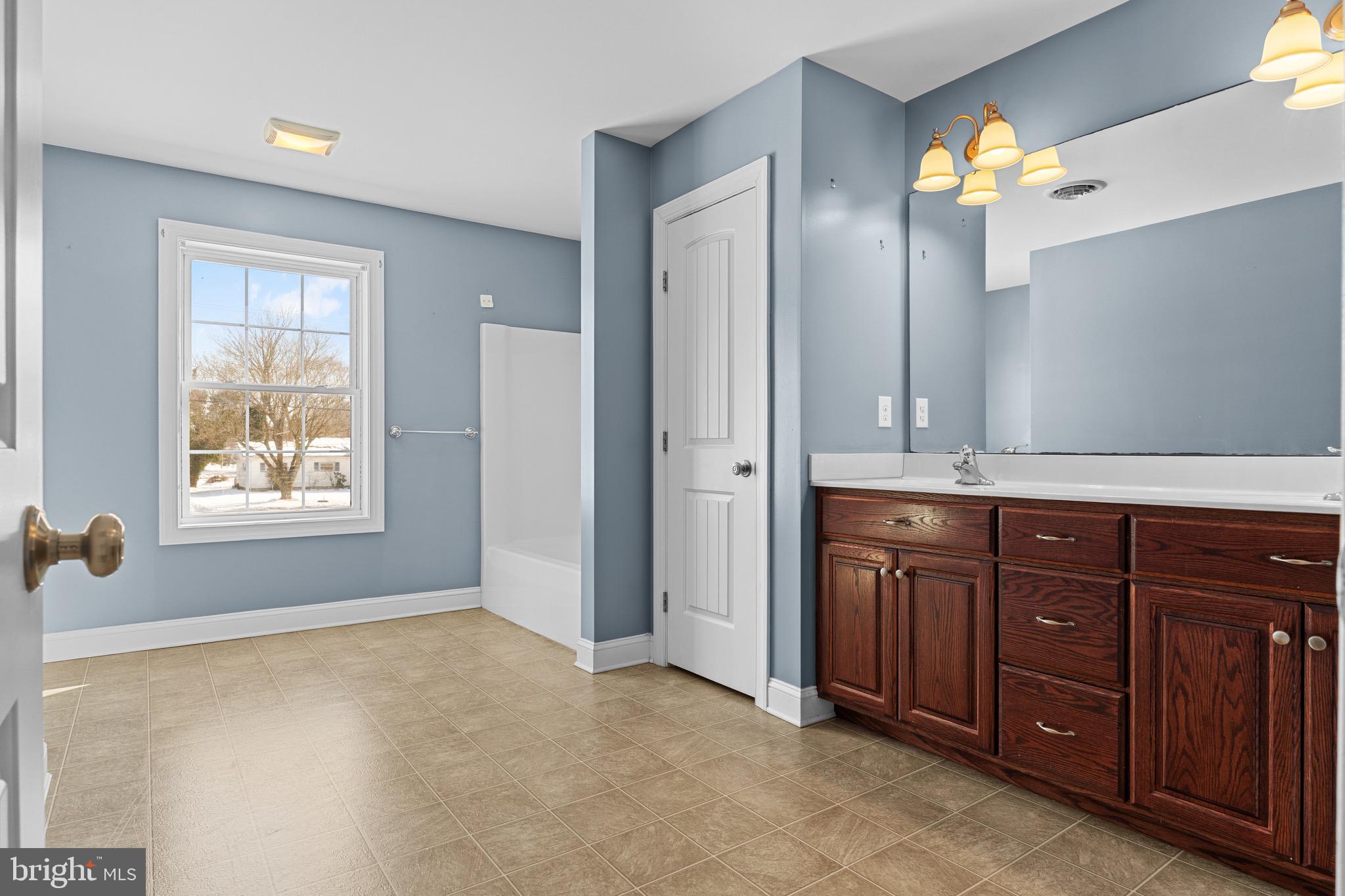 7180 Shawnee Road Milford, DE 19963 - Photo 18 of 20 a bathroom with a sink and a mirror