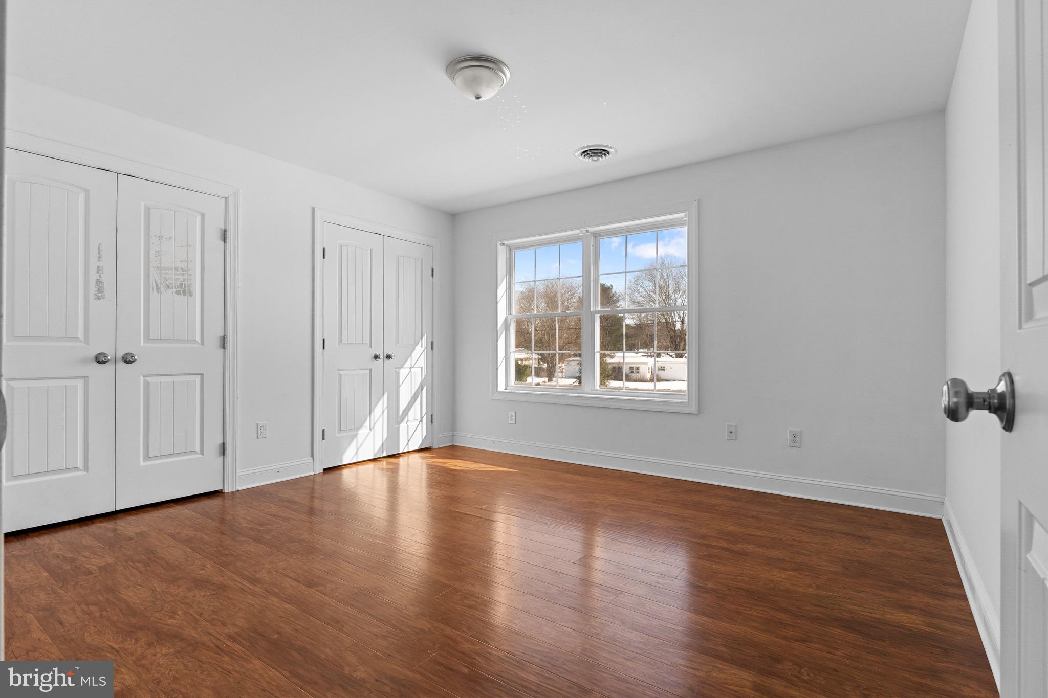 7180 Shawnee Road Milford, DE 19963 - Photo 19 of 20 wooden floor in an empty room with a window