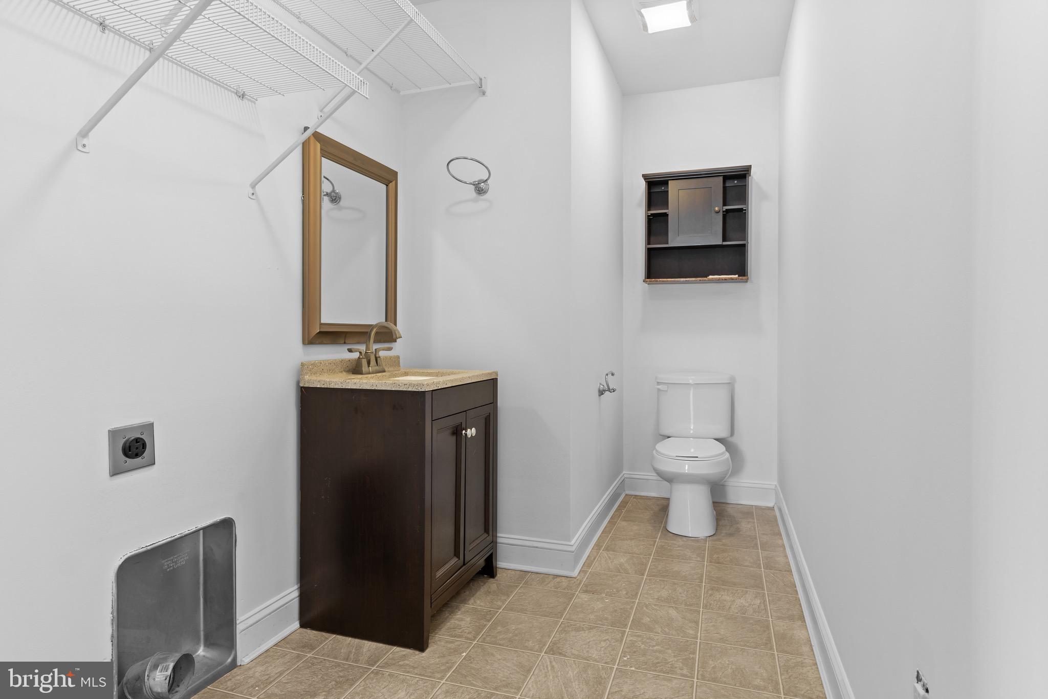 7180 Shawnee Road Milford, DE 19963 - Photo 10 of 20 a bathroom with a sink toilet and mirror