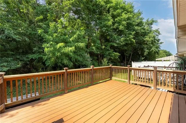 a view of balcony with wooden floor and fence