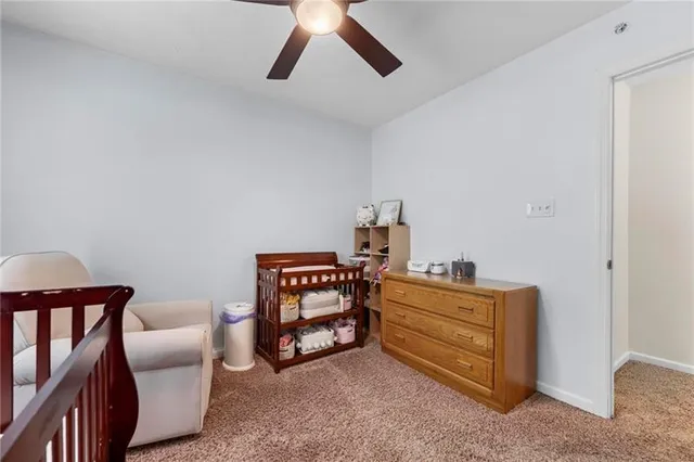a room with furniture and ceiling fan