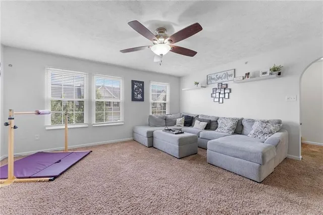 a living room with furniture and windows