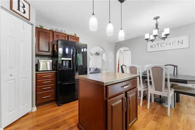 a kitchen with stainless steel appliances granite countertop a refrigerator and a stove top oven