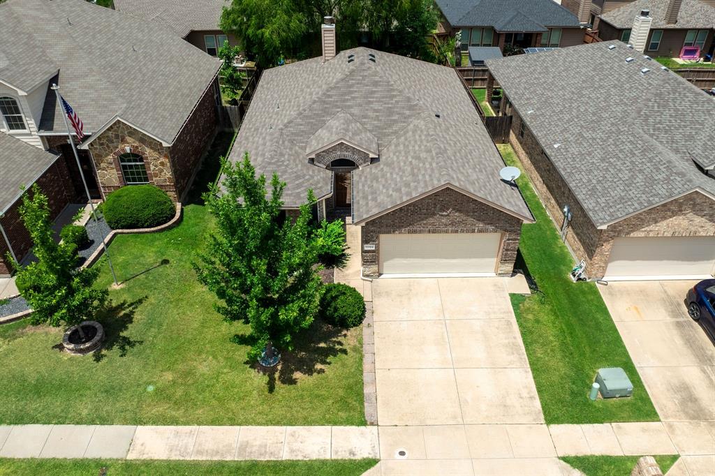 11156 Hawks Landing Road Fort Worth, TX 76052 - Photo 2 of 30 Traditional brick residence featuring a concrete driveway, attached garage, and a gabled roof