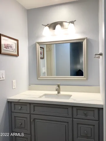 a bathroom with a sink and a mirror