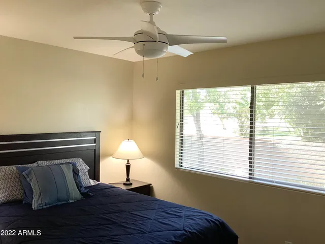a bedroom with a bed and a window
